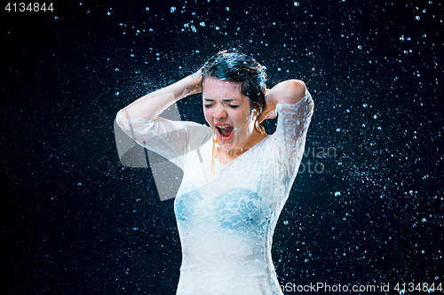 Image of The young girl standing under running water