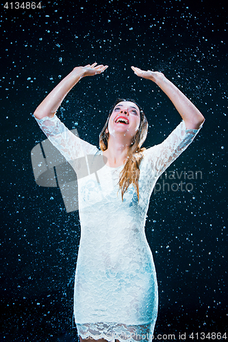 Image of The young girl standing under running water