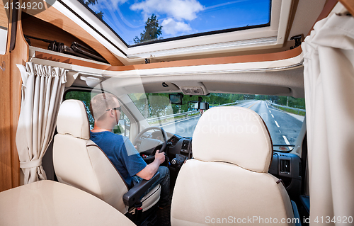 Image of Man driving on a road in the Camper Van