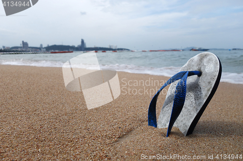 Image of Beach slippers on a sandy beach