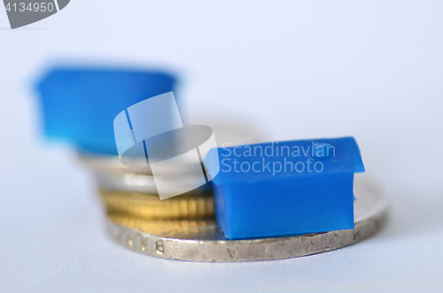 Image of Little plastic house on metal coins