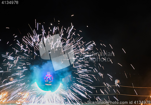 Image of Artists juggling with burning poi\'s at fire performance.