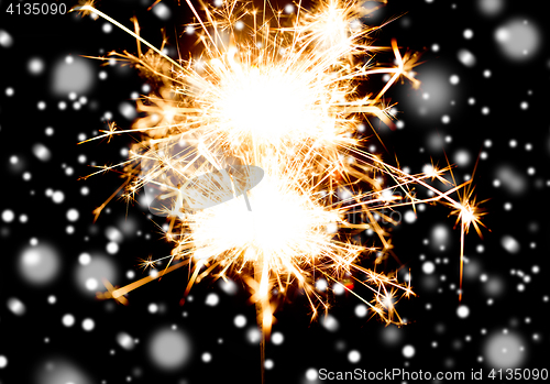 Image of sparkler or bengal light burning over black