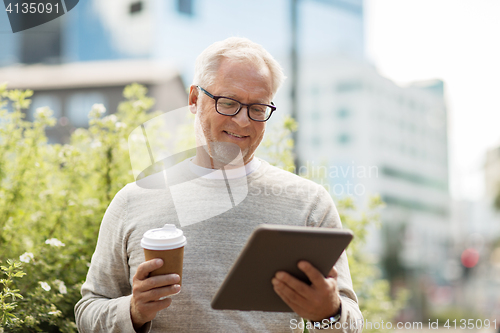 Image of senior man with tablet pc and coffee in city