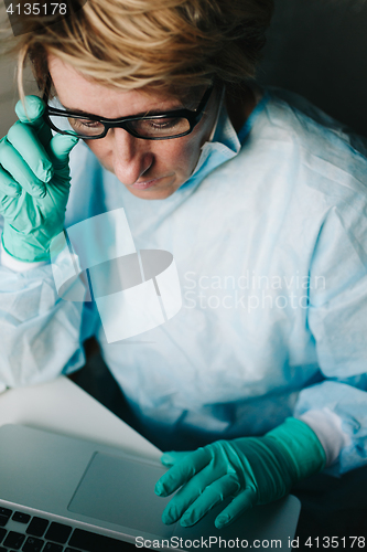 Image of Front view of scientist working on laptop