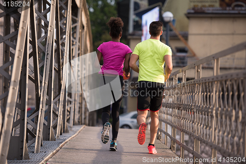 Image of multiethnic couple jogging in the city