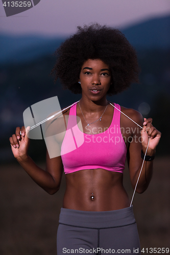 Image of portrait of african american woman jogging in nature