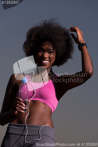 Image of african american woman jogging in nature