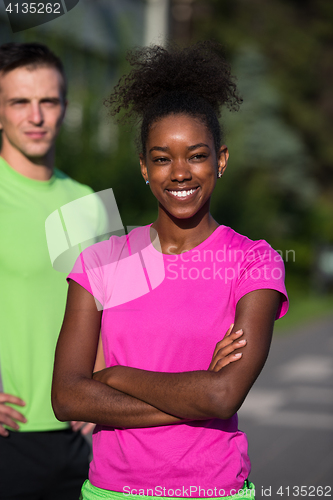 Image of portrait of young multietnic jogging couple ready to run