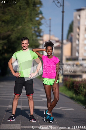 Image of portrait of young multietnic jogging couple ready to run