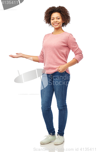 Image of happy african woman holding something imaginary