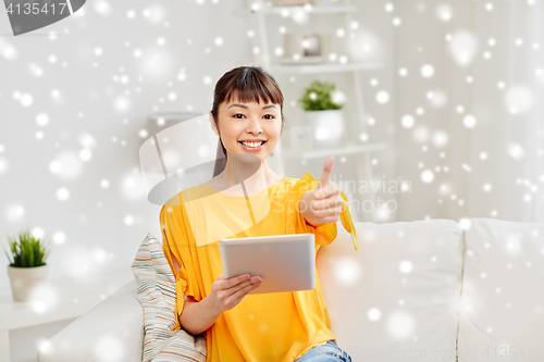 Image of happy asian woman with tablet pc and thumbs up