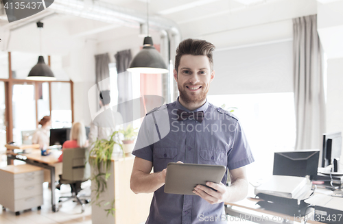 Image of happy creative male office worker with tablet pc