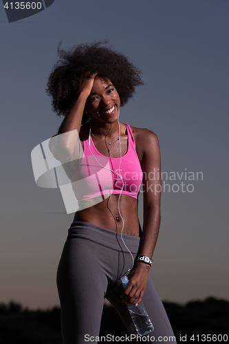 Image of african american woman jogging in nature