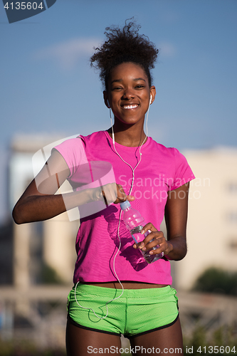 Image of african american woman running outdoors