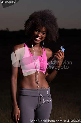 Image of african american woman jogging in nature