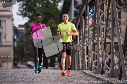 Image of multiethnic couple jogging in the city