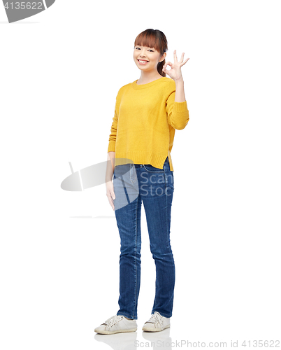 Image of happy asian young woman showing ok hand sign