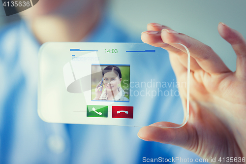 Image of close up of woman with transparent smartphone