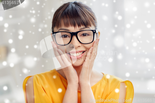 Image of happy asian young woman in glasses at home