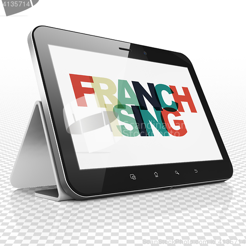 Image of Business concept: Tablet Computer with Franchising on  display