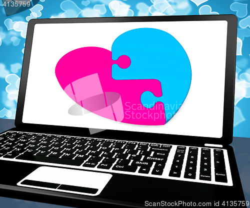 Image of Puzzle Heart On Laptop Showing Online Dating