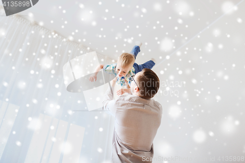 Image of father with son playing and having fun at home