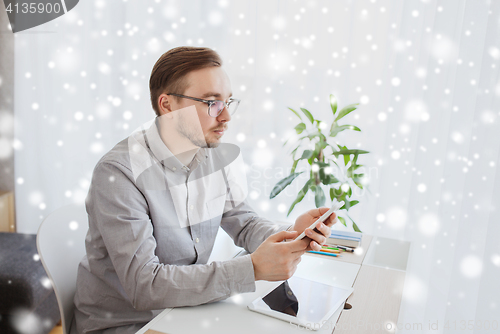 Image of creative male office worker texting on smarphone