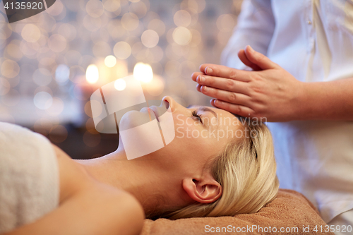 Image of close up of woman having face massage in spa