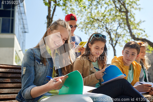 Image of group of students with notebooks at school yard