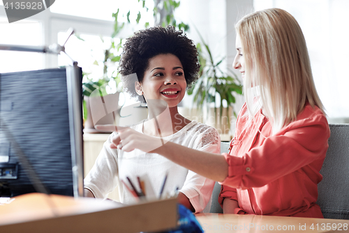 Image of happy women or students with computer in office