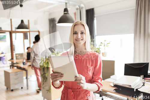 Image of happy creative female office worker with tablet pc