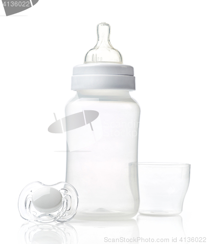 Image of Empty baby bottle and pacifier