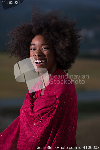 Image of outdoor portrait of a black woman with a scarf