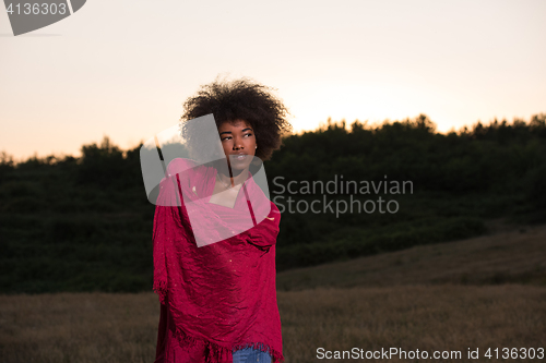 Image of outdoor portrait of a black woman with a scarf