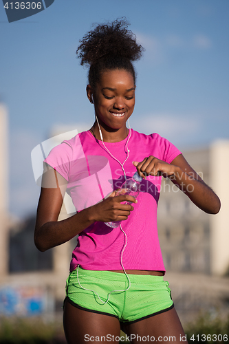 Image of african american woman running outdoors