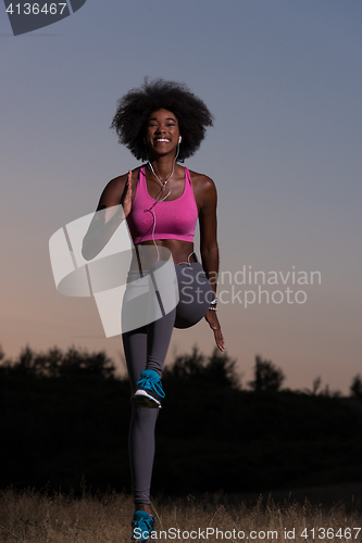 Image of black woman is doing stretching exercise relaxing and warm up