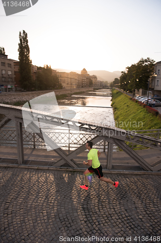 Image of a young man jogging in the city