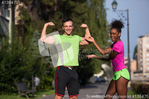 Image of portrait of young multietnic jogging couple ready to run