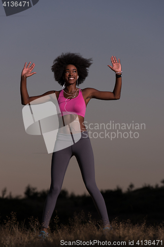 Image of black woman is doing stretching exercise relaxing and warm up