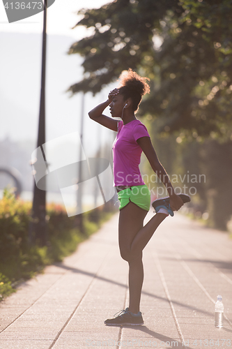 Image of Black woman doing warming up and stretching