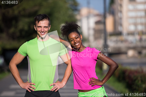 Image of portrait of young multietnic jogging couple ready to run