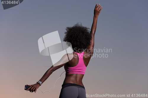 Image of young black girl dances outdoors