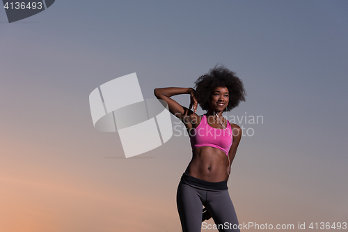 Image of black woman is doing stretching exercise relaxing and warm up