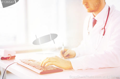 Image of male doctor typing  on the keyboard