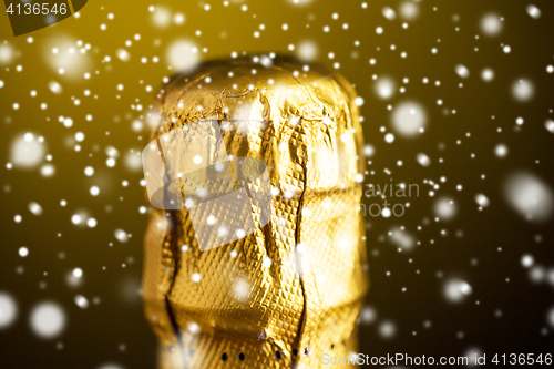 Image of close up of champagne bottle cork wrapped in foil