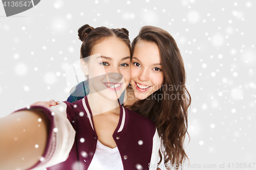 Image of happy smiling pretty teenage girls taking selfie