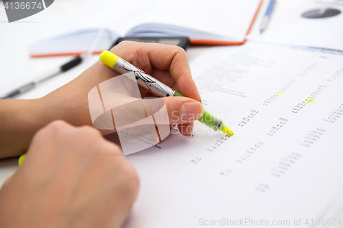 Image of Girl works with paperwork, reports
