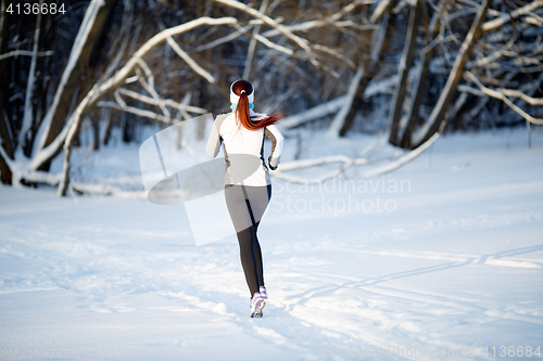 Image of Female athlete on winter jogging