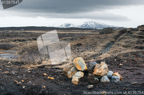 Image of Icelandic landscape with rocks on a field